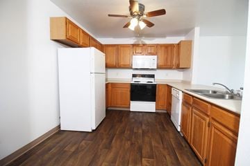 Altoona apartment for rent - A kitchen with wooden floors and white appliances.