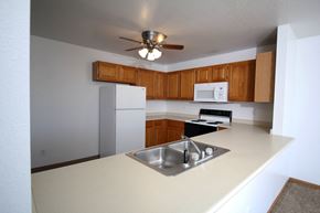 Altoona apartment for rent - a kitchen with white appliances and wooden cabinets