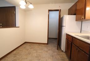 Urbandale apartment for rent - a kitchen with a refrigerator and a sink