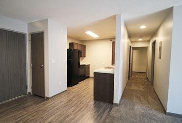 Des Moines apartment for rent - A long hallway with a kitchen area at the end.