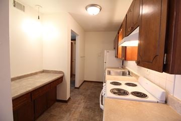 Urbandale apartment for rent - A kitchen with a stove top oven and a sink.