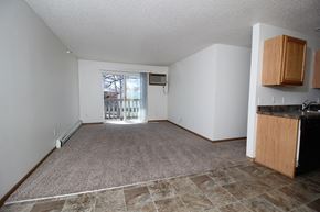 Des Moines apartment for rent - an empty living room with a door leading to a balcony