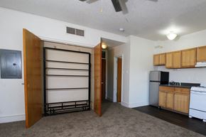 Des Moines apartment for rent - a kitchen with a refrigerator freezer next to a stove top oven