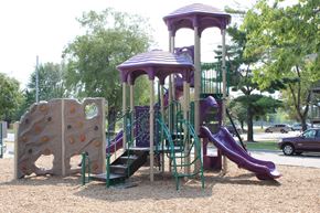 Des Moines apartment for rent - a playground with a rock climbing wall and slides