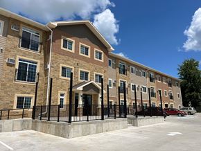 Marshalltown apartment for rent - a three story apartment building with cars parked outside