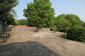 Des Moines apartment for rent - A backyard with a picnic table and a trampoline.