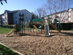 Des Moines apartment for rent - a playground with a slide and monkey bars