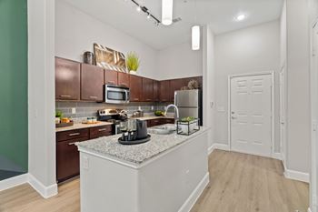 Modern kitchen with island and white pendant lights