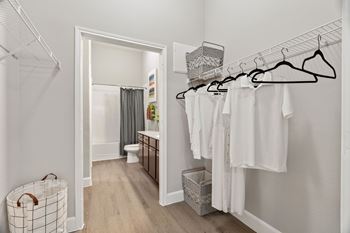 Walk-in closet with organized white clothing