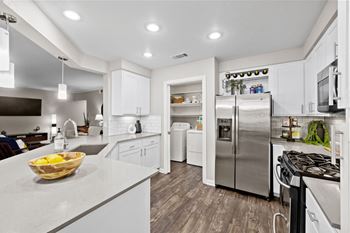 Modern kitchen with white cabinetry and pantry