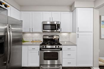 Modern kitchen with white cabinets and stainless appliances
