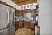 San Antonio apartment for rent - Modern kitchen with mosaic backsplash and wood cabinets at Urban Crest Apartments, San Antonio, 78209