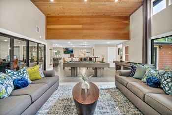 A living room with couches and a pool table