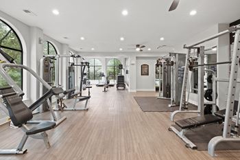 Fitness center with weight machines and arched windows