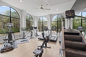 Fitness center with cardio machines and large windows