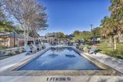 San Antonio apartment for rent - a swimming pool with chairs around it and a patio with umbrellas  at Sunset Ridge, Texas