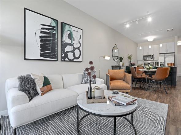 Ann Arbor apartment for rent - A living room with a white couch and two abstract paintings on the wall.