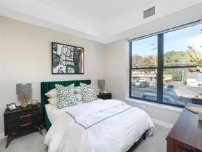 Ann Arbor apartment for rent - A bedroom with a large bed and a painting on the wall.