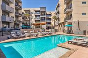 San Antonio apartment for rent - Swimming pool with lounge chairs and modern buildings at Urban Crest Apartments, San Antonio, 78209