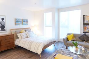 Los Angeles apartment for rent - a bedroom with a bed and a chair and a table