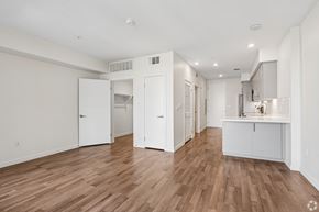 Los Angeles apartment for rent - A kitchen area with white cabinets and a wooden floor.