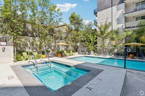 Los Angeles apartment for rent - A swimming pool surrounded by trees and chairs.