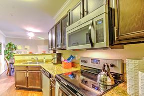 Houston apartment for rent - a kitchen with stainless steel appliances and a microwave at Stone Creek at Old Farm Apartments, Houston, Texas