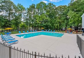 Marietta apartment for rent - a swimming pool with chaise lounge chairs and trees in the background