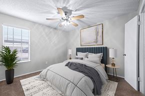 Irving apartment for rent - a bedroom with a bed and a ceiling fan
