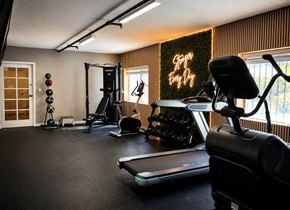 Sherman Oaks apartment for rent - A home gym with a treadmill, weights, and exercise equipment.