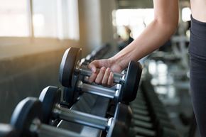 Charlotte apartment for rent - a woman holding dumbbells on a treadmill in a gym