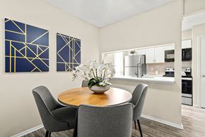 Carrollton apartment for rent - a dining room with a table and chairs and a kitchen at Keller Oaks, Carrollton