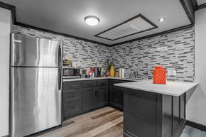 Dallas townhouse for rent - A kitchen with a stainless steel refrigerator and a stone backsplash.
