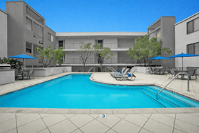Valley Village apartment for rent - A swimming pool in front of a building with a blue sky.