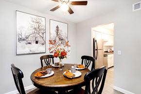 Nashville townhouse for rent - A dining room with a table set for two and a framed picture on the wall.