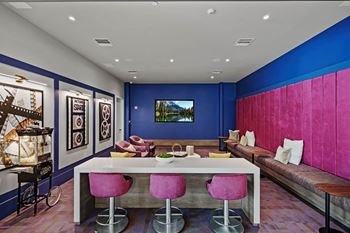 A living room with blue walls and a white table and chairs