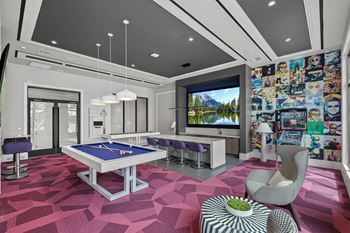 A game room with a pool table and a tv