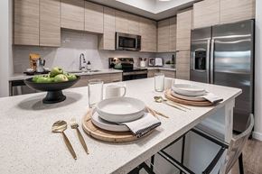Miami apartment for rent - a kitchen with stainless steel appliances and white counter tops at Altis Grand Kendall, Miami, FL