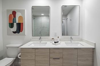 A bathroom with two sinks and a mirror