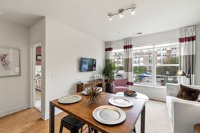 Alexandria apartment for rent - A dining room with a wooden table and chairs.