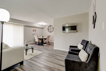 Suitland apartment for rent - A living room with a grey couch and a white sofa.