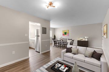 Forestville apartment for rent - A living room with a white couch and a coffee table.