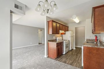 Suitland apartment for rent - A kitchen with brown cabinets and white appliances.
