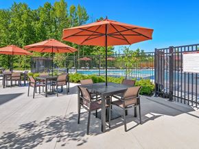 Aberdeen apartment for rent - our patio has tables and chairs with umbrellas and a pool in the background