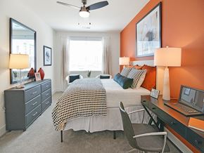 Aberdeen apartment for rent - a bedroom with a bed and a desk with a laptop