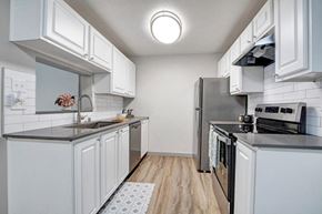 Mountlake Terrace apartment for rent - a kitchen with a stove top oven next to a refrigerator