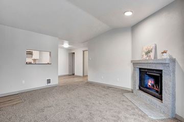 Mountlake Terrace apartment for rent - a living room with a fireplace and a rug