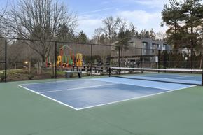 Mountlake Terrace apartment for rent - A tennis court with a playground in the background.