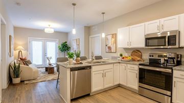 Sellersburg apartment for rent - A modern kitchen with white cabinets and stainless steel appliances.