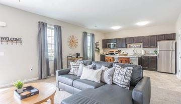 Richmond apartment for rent - A living room with a grey couch and a wooden coffee table.